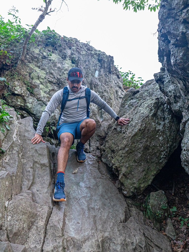 Man tackling the rock scramble at Bearfence Mountain.