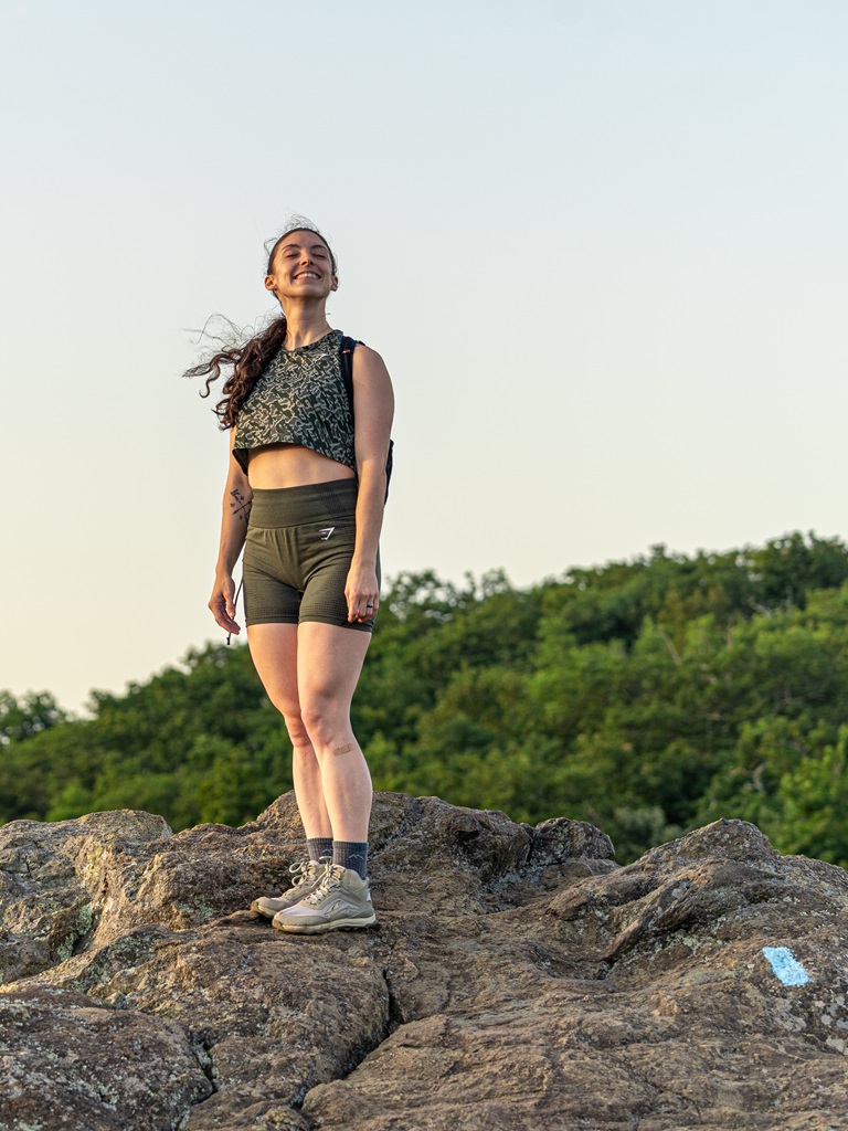 Woman standing on the summit of Bearfence Mountain in Shenandoah National Park.