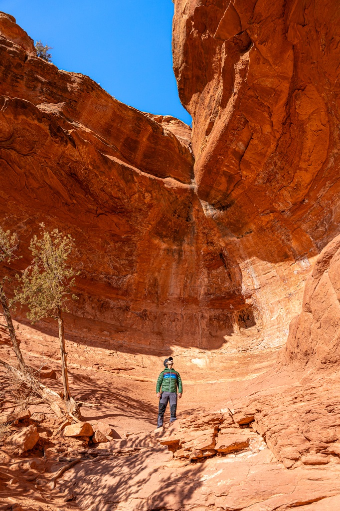 Man standing inside the Birthing Cave in Sedona looking up.