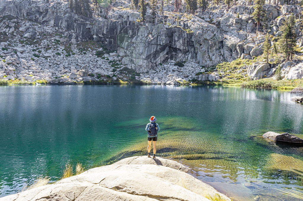 Woman standing in front of Heather Lake in Sequoia National Park.