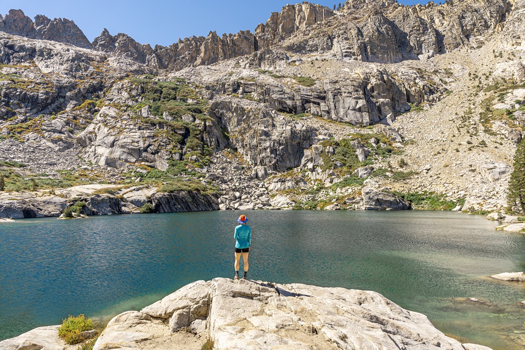 Woman standing in front of Emerald Lake in Sequoia National Park.