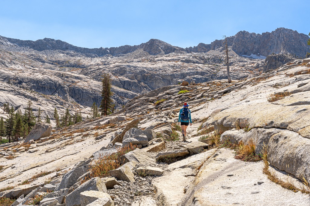 Woman hiking along the Lakes Trail towards Pear Lake.