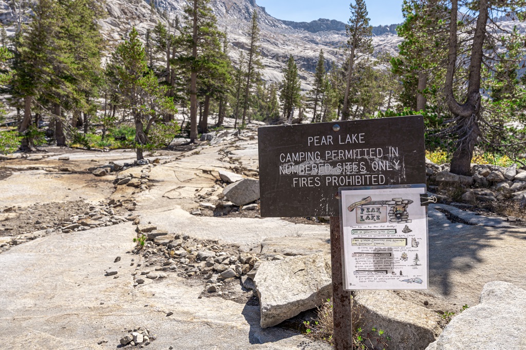 Trail sign that states Pear Lake - Camping Permitted in Numbered Sites Only - Fires Prohibited.