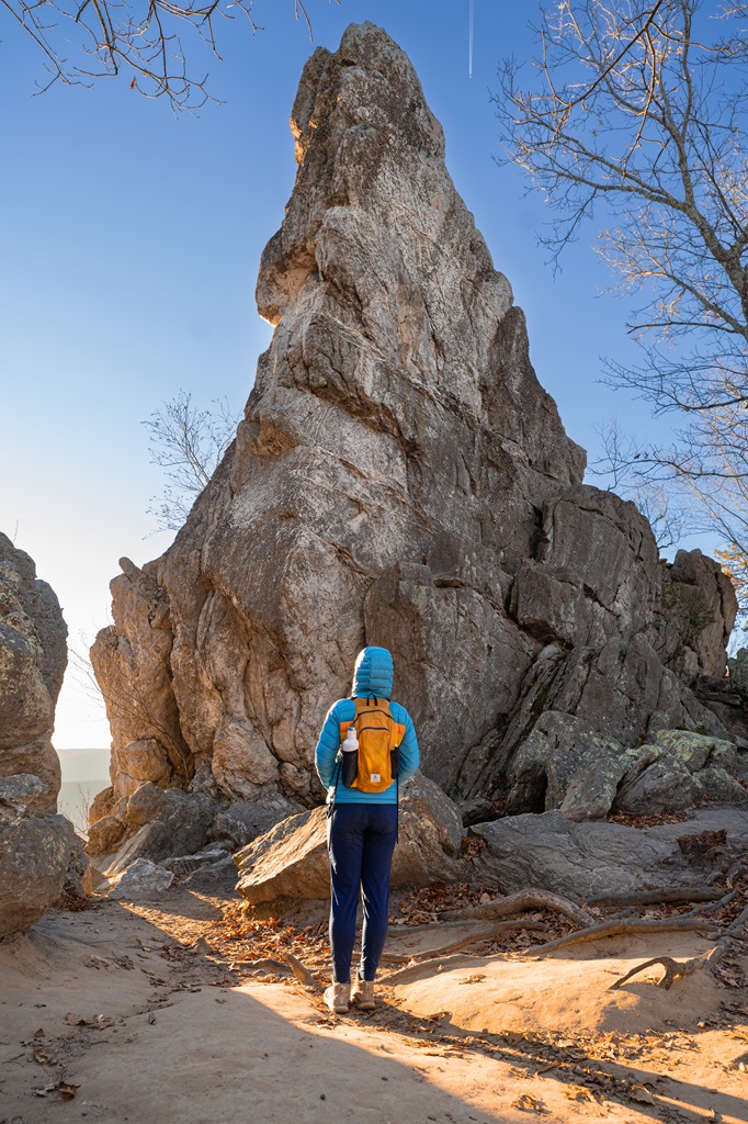 Woman standing in front of the Dragon's Tooth rock formation in Virginia.