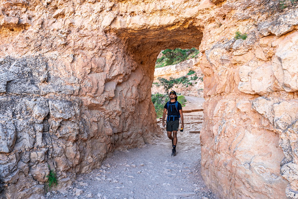 Man walking through a tunnel along the Bright Angel Trail in Grand Canyon National Park.