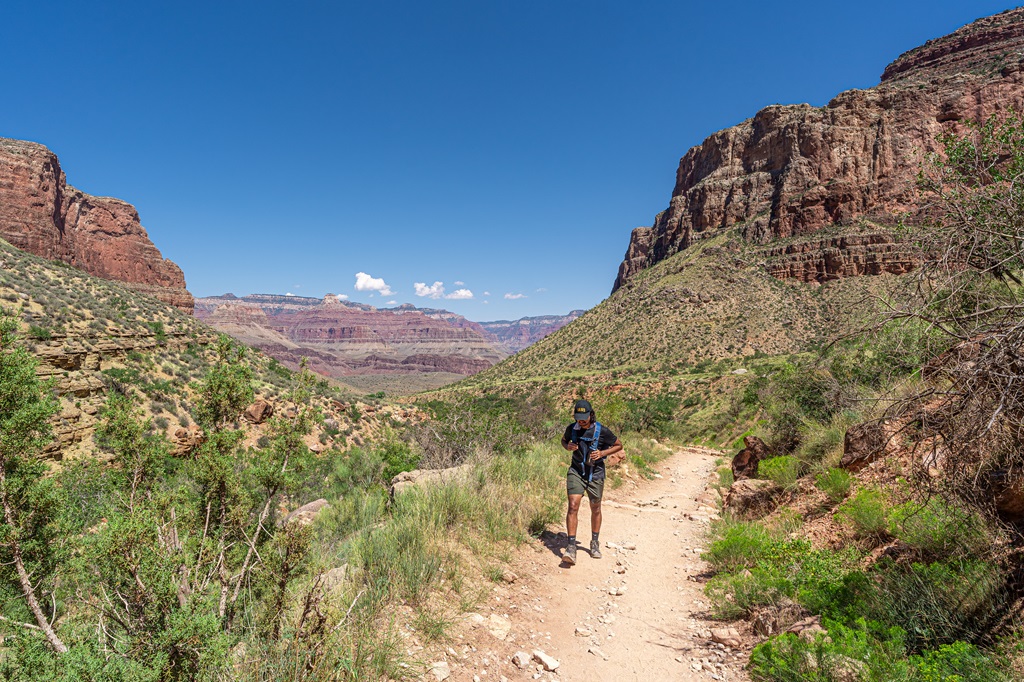 Man hiking along the Bright Angel Trail in Grand Canyon.