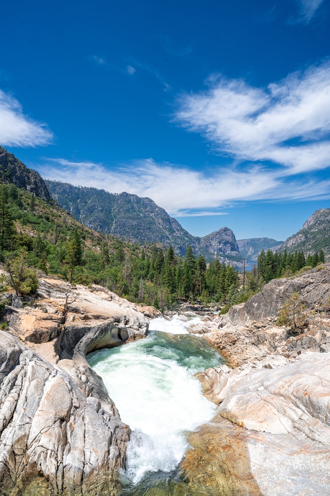 Rancheria Falls with granite peaks and Hetch Hetchy Reservoir in the distance.