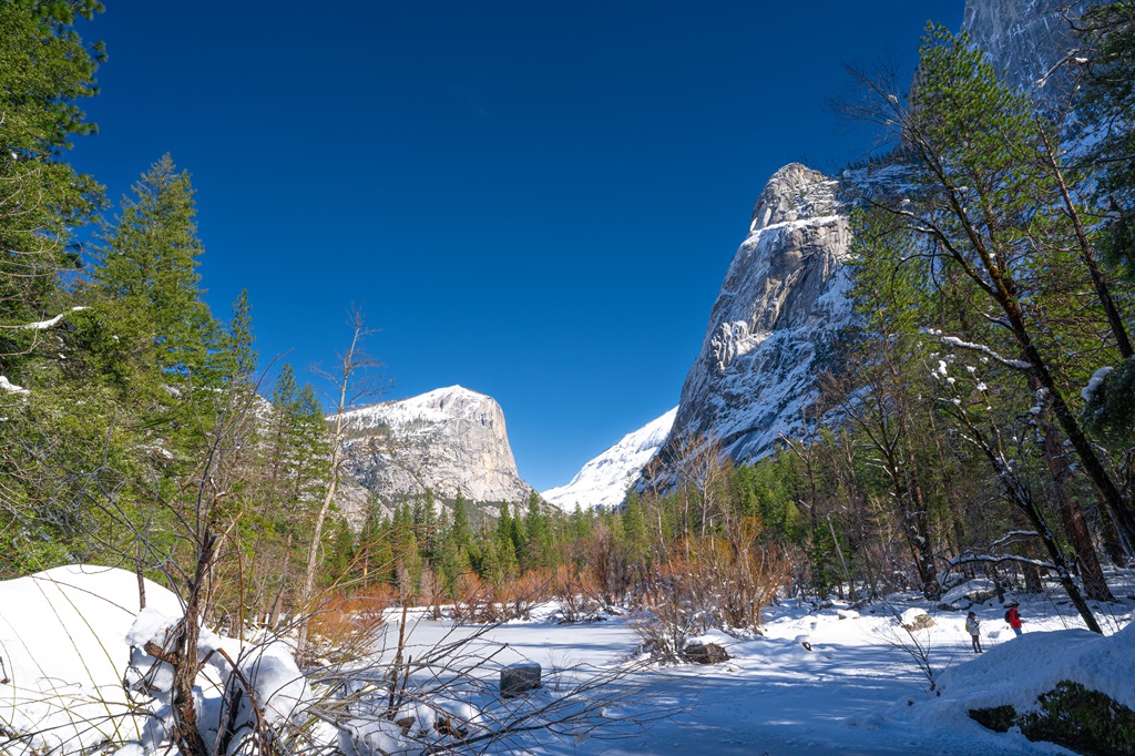 Snow-covered peaks and frozen lake in Yosemite National Park in winter.