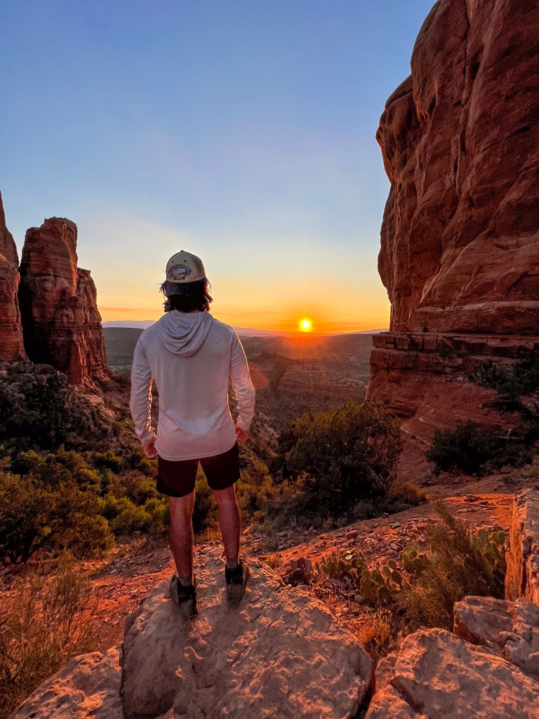 Man watching the sunset from the top of Cathedral Rock.