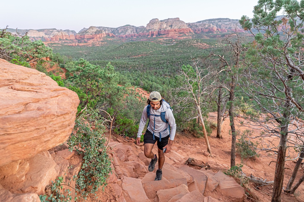 Man hiking up rocky steps heading towards Devil's Bridge.