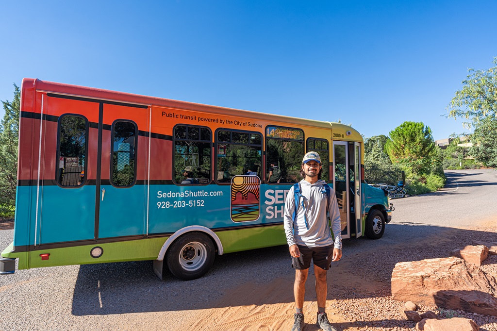 Man standing in front of the Sedona shuttle bus.