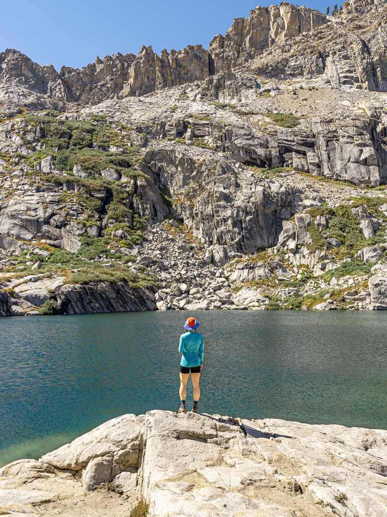 Woman standing in front of Emerald Lake in Sequoia National Park.