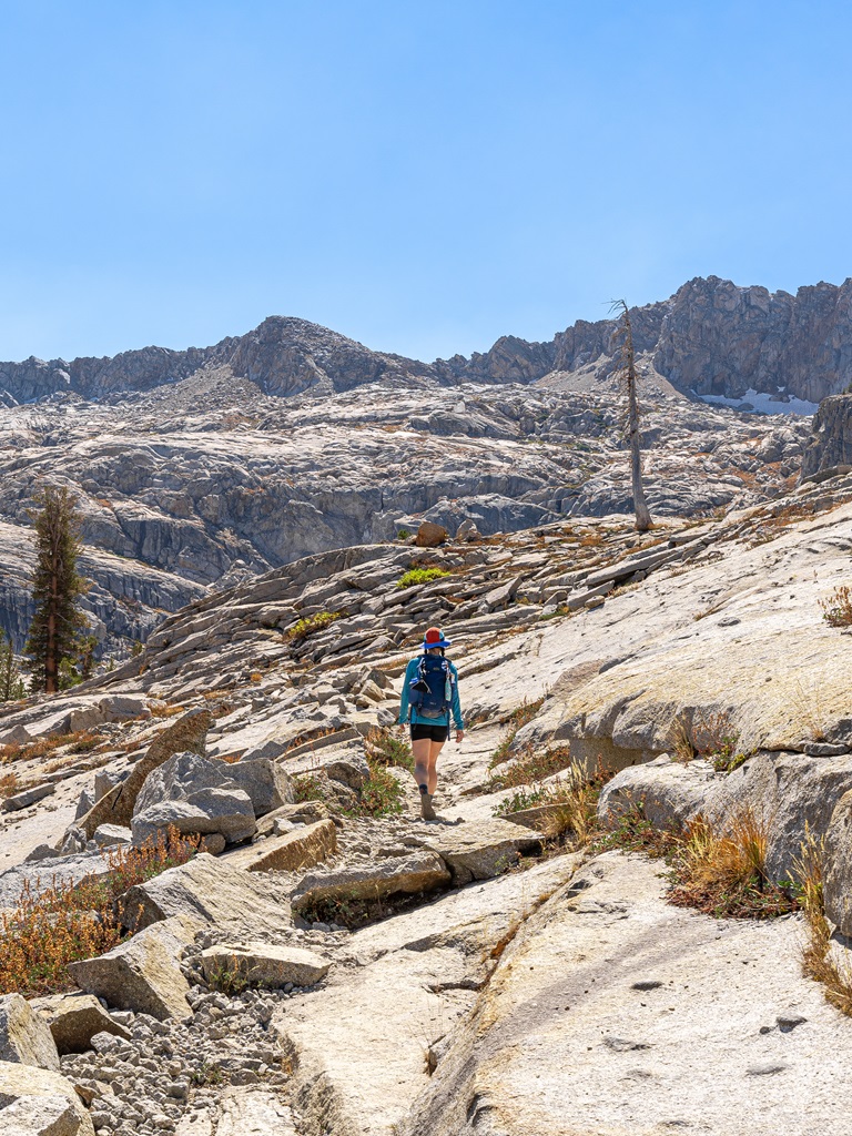 Woman hiking along the Lakes Trail towards Pear Lake.