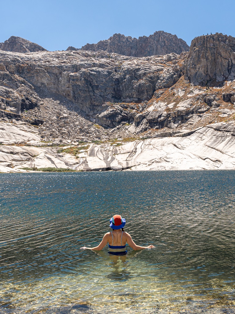 Woman cold plunging in Pear Lake in Sequoia National Park.