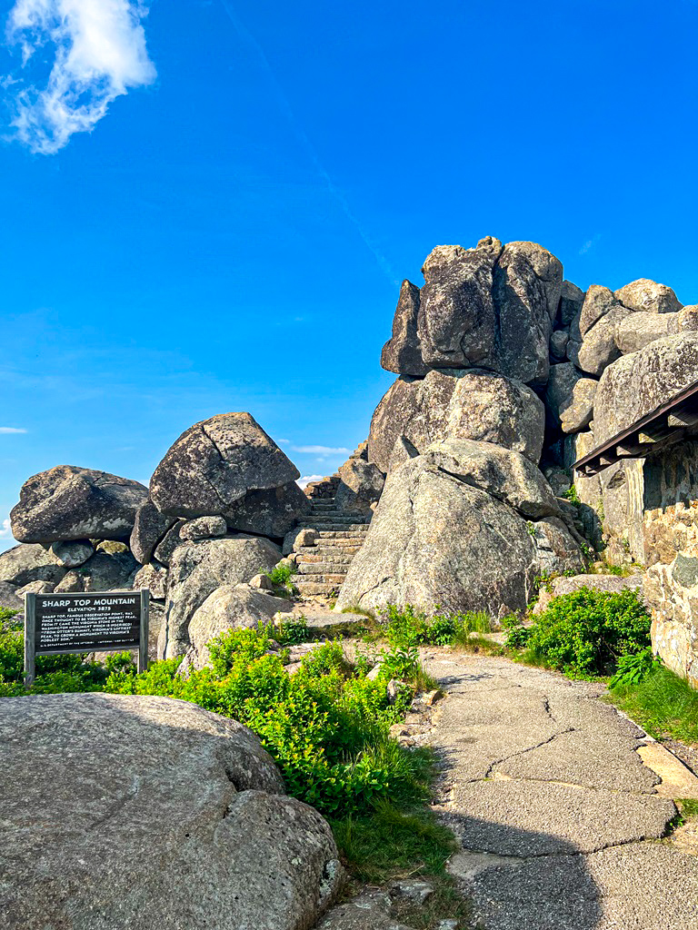 Sharp Top Mountain stone shelter and sign providing more information about Sharp Top.