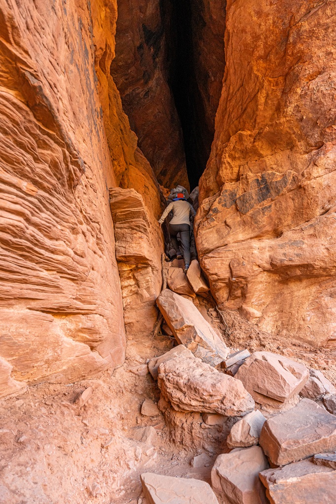 Woman climbing into the Soldier Pass Cave in Sedona.