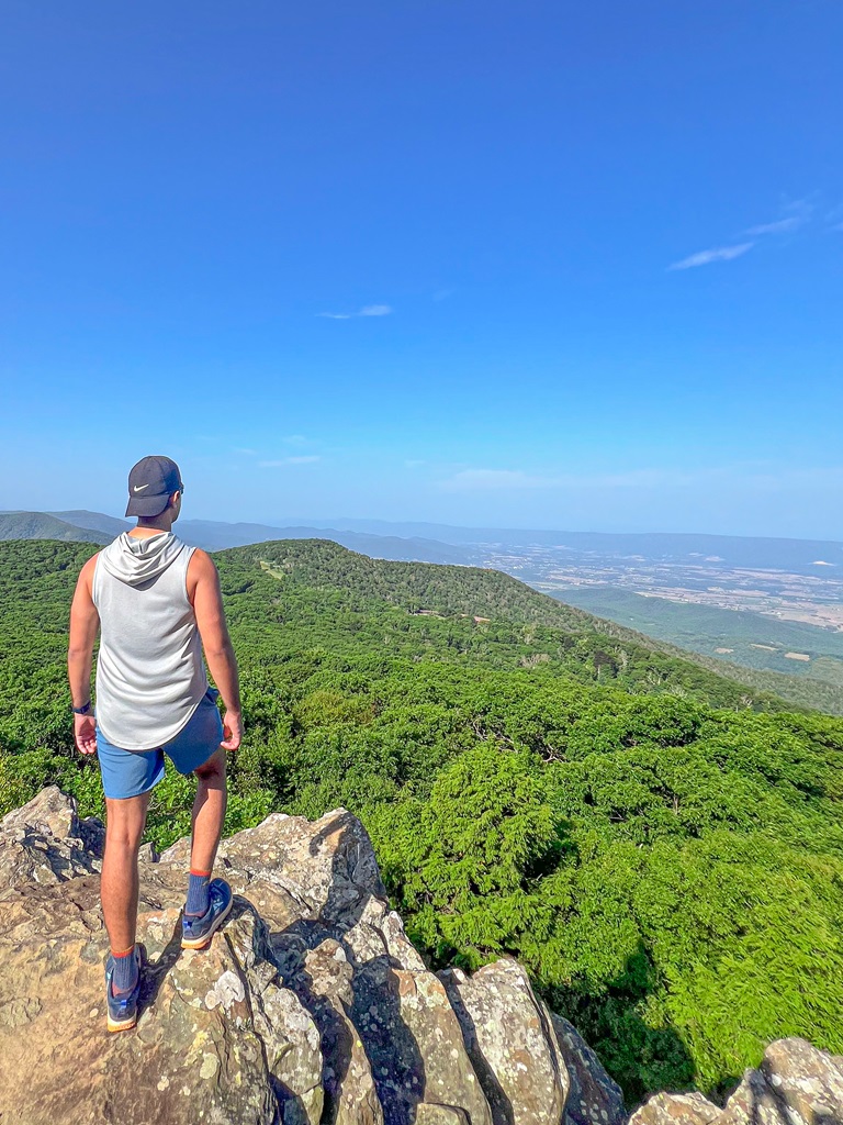 Man standing on Stony Man Summit looking at the views in Shenandoah National Park.