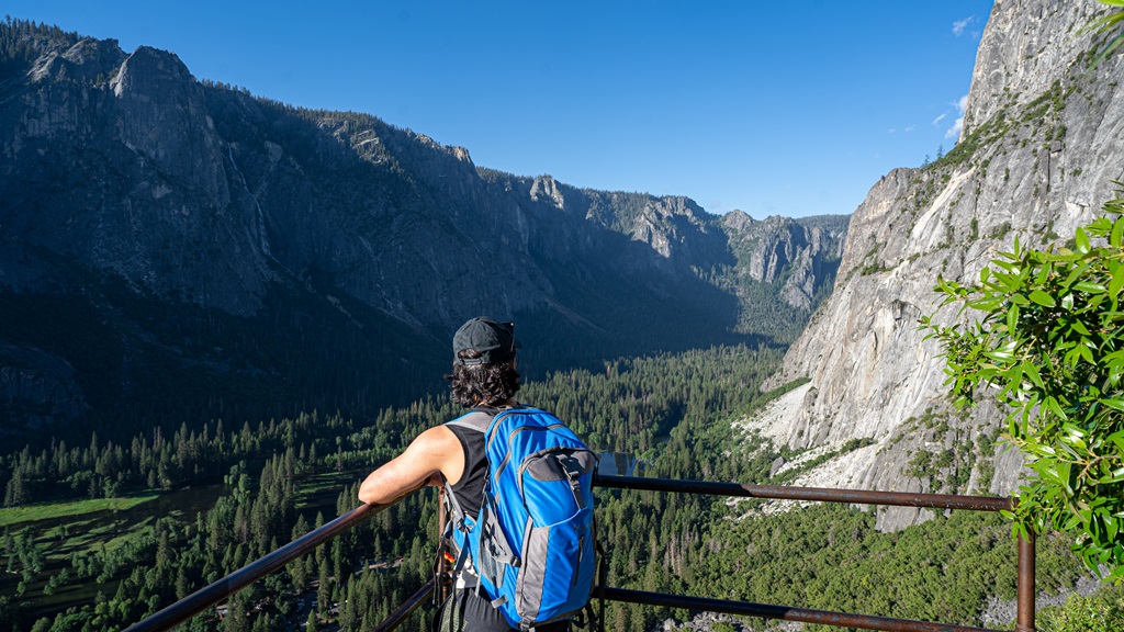 Man looking at the views from Columbia Rock along the Upper Yosemite Falls trail.