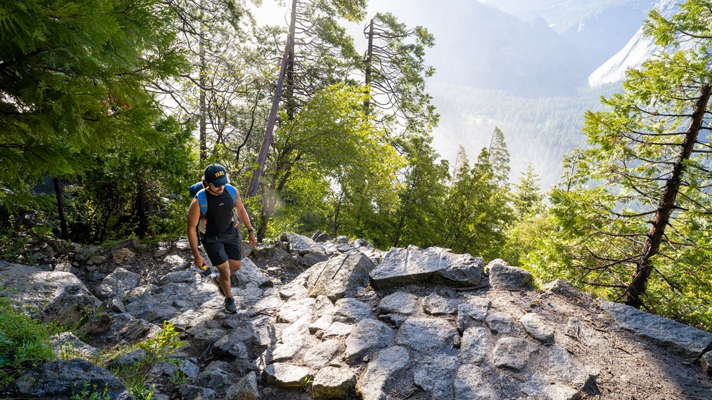 Man hiking along the Upper Yosemite Falls trail located in Yosemite National Park.