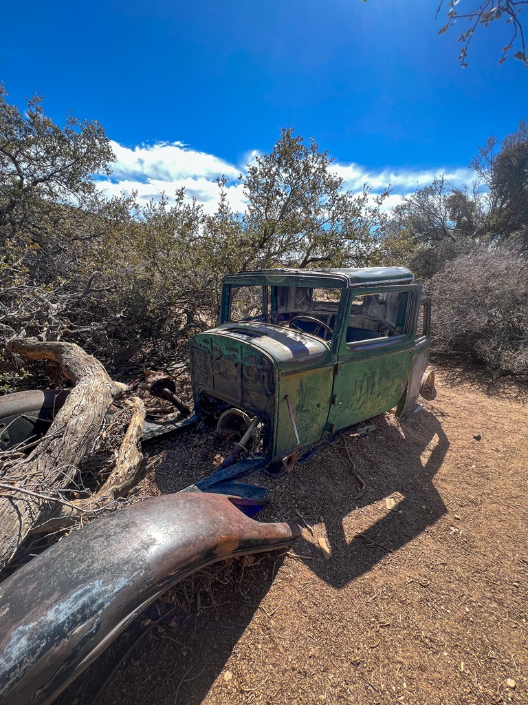 Old rusty green car located along the Wall Street Mill Trail in Joshua Tree National Park.