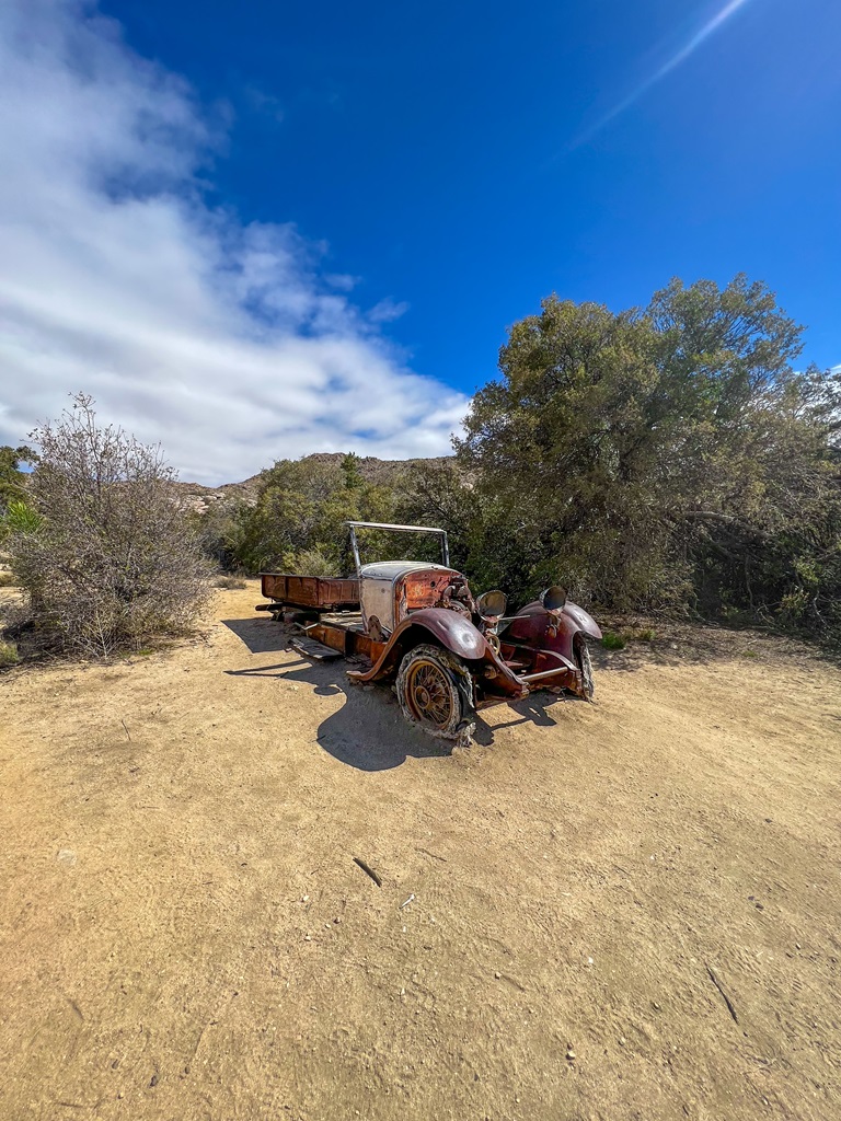 Old rusty brown car located along the Wall Street Mill Trail in Joshua Tree National Park.