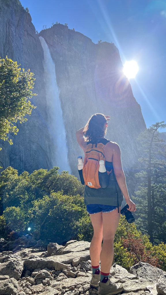 Woman looking at Upper Yosemite Falls on the trail.