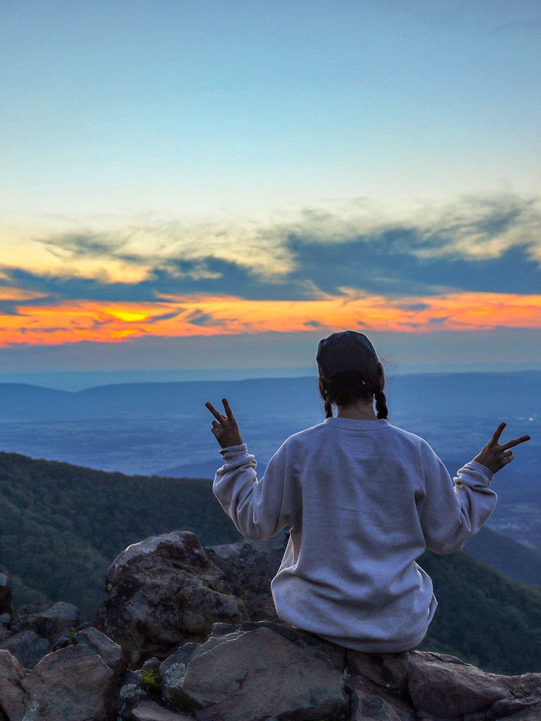 Woman watching sunset at Hawksbill Summit in Shenandoah National Park.