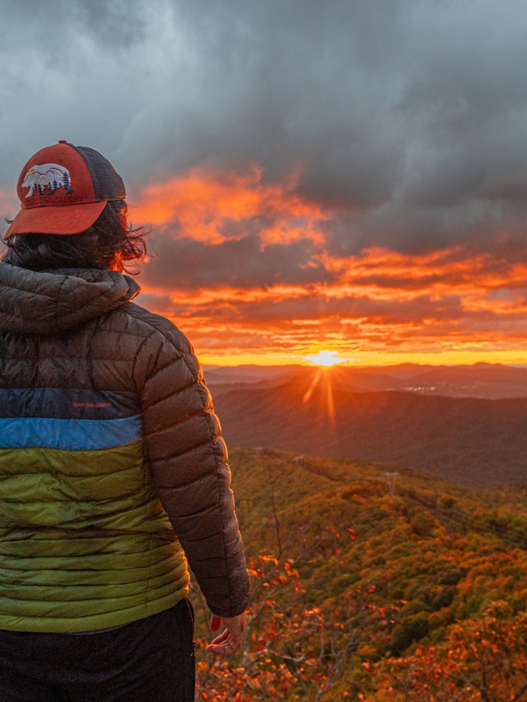 Man watching sunrise from McAfee Knob in Virginia.