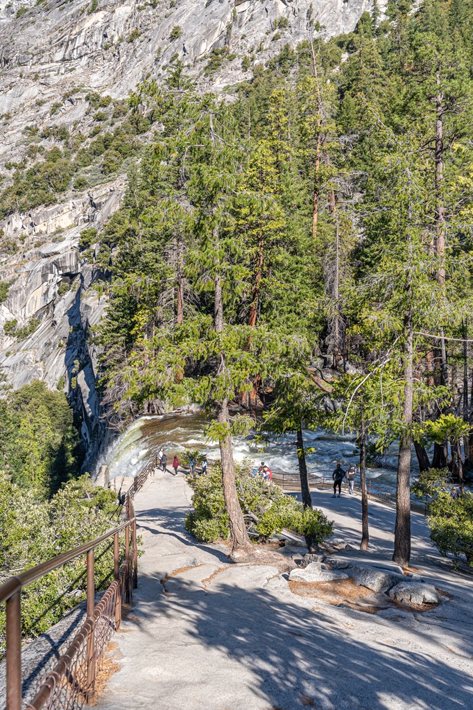 Large granite space for hikers to relax near the top of Vernal Fall with guard rails all around.