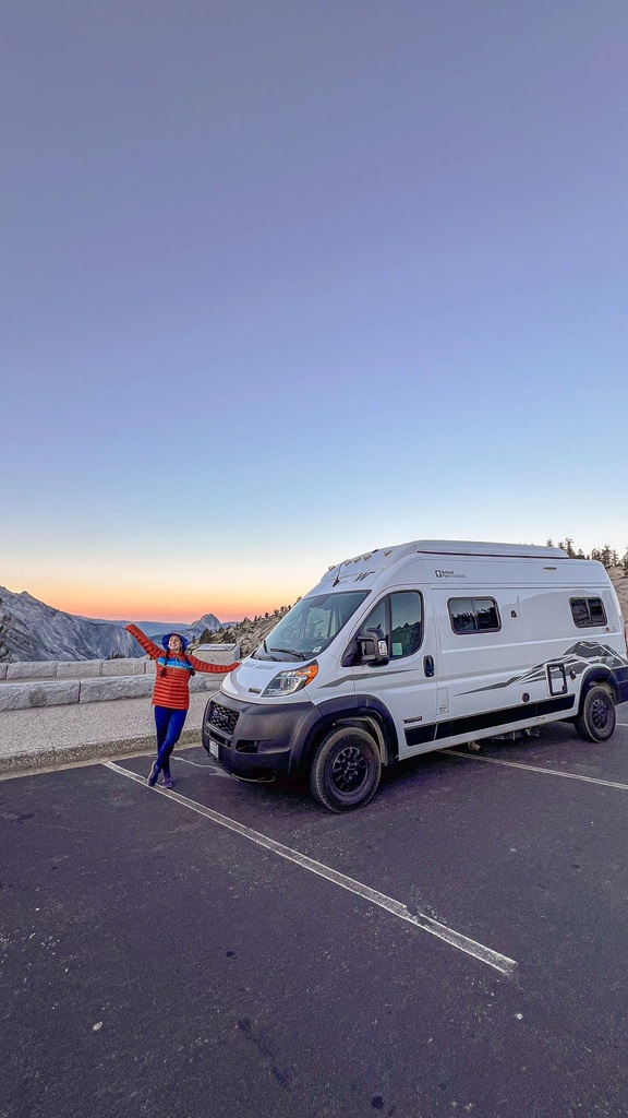 Woman posing next to a converted van at Olmsted Point in Yosemite National Park.