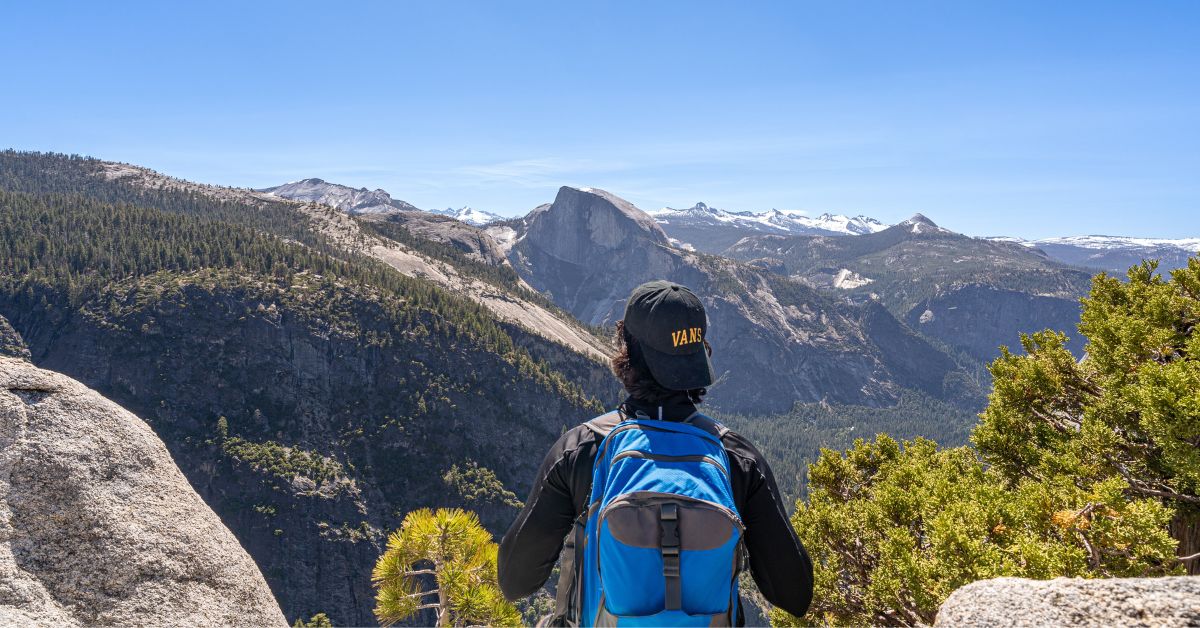 Man looking at the views from Yosemite Point.