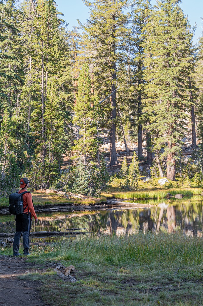 Man looking at a pond along the Clouds Rest Trail in Yosemite.