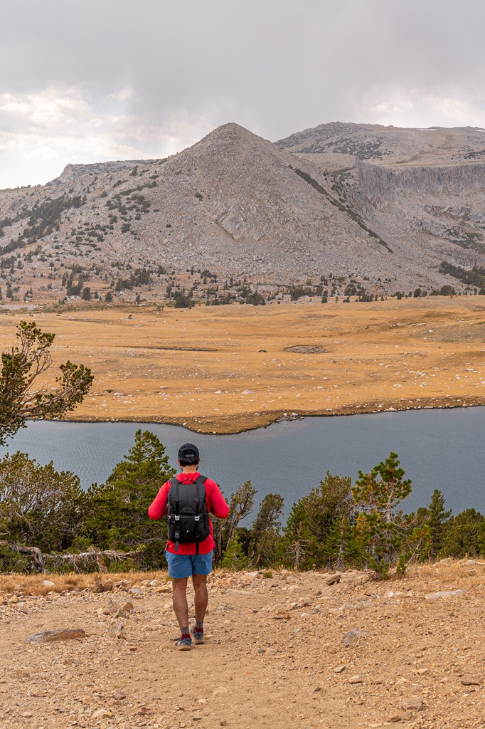 Man hiking towards Middle Gaylor Lake in Yosemite.