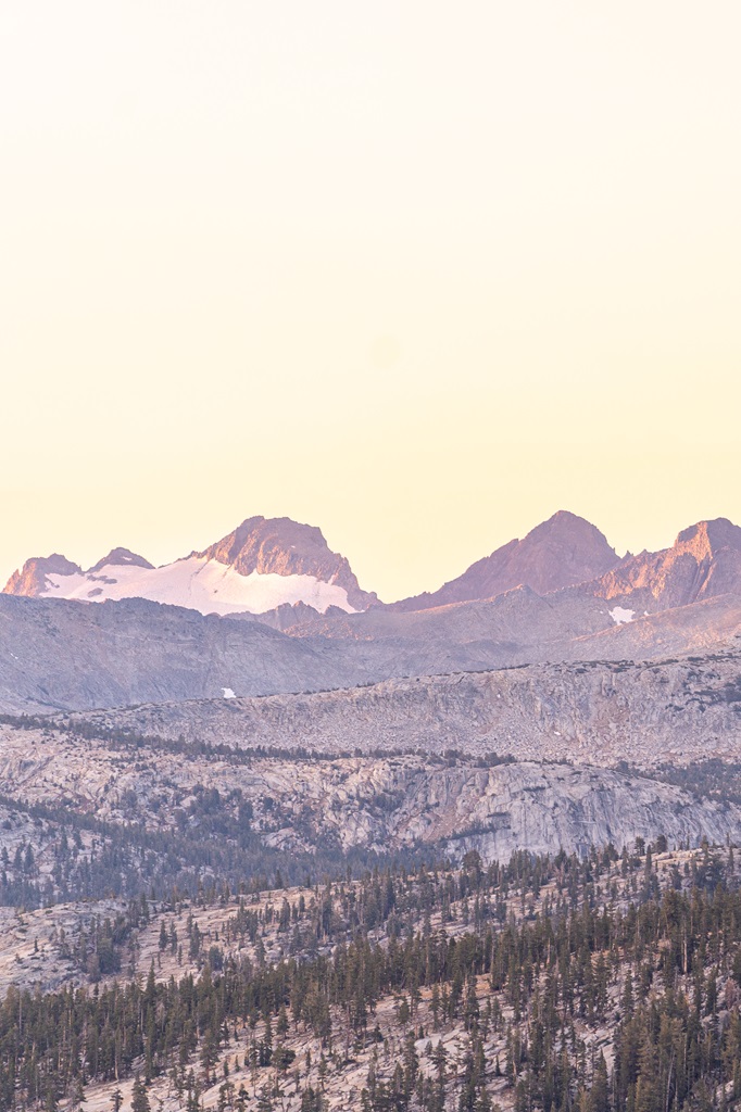 View of snowy mountain peaks from Lembert Dome during sunrise.