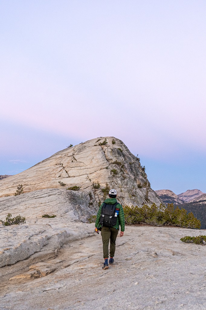 Man walking towards Lembert Dome in Yosemite.