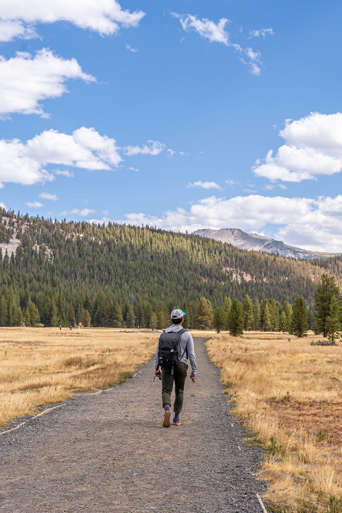 Man walking along a trail in Tuolumne Meadows in Yosemite.