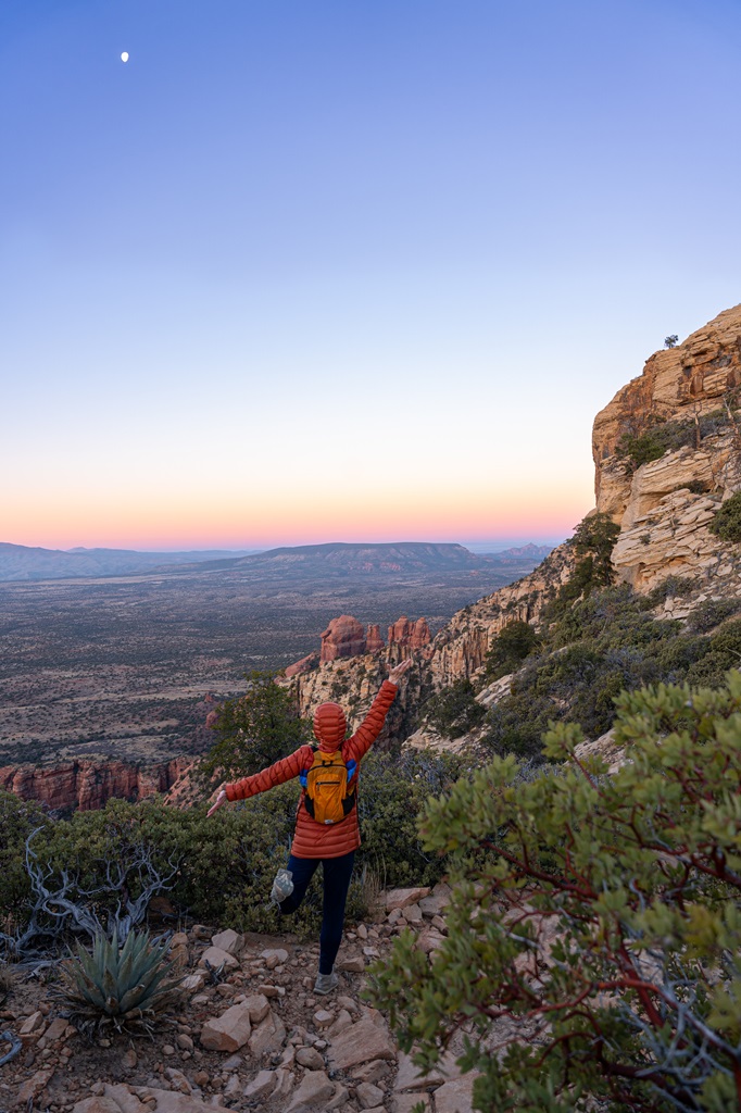 Woman posing for a picture along the Bear Mountain Trail during sunrise in Sedona.