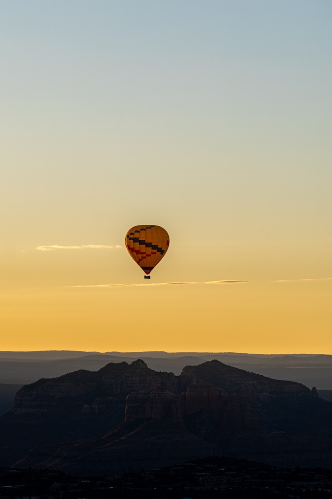 Hot air balloon drifting through the sky during sunrise seen from Doe Mountain.