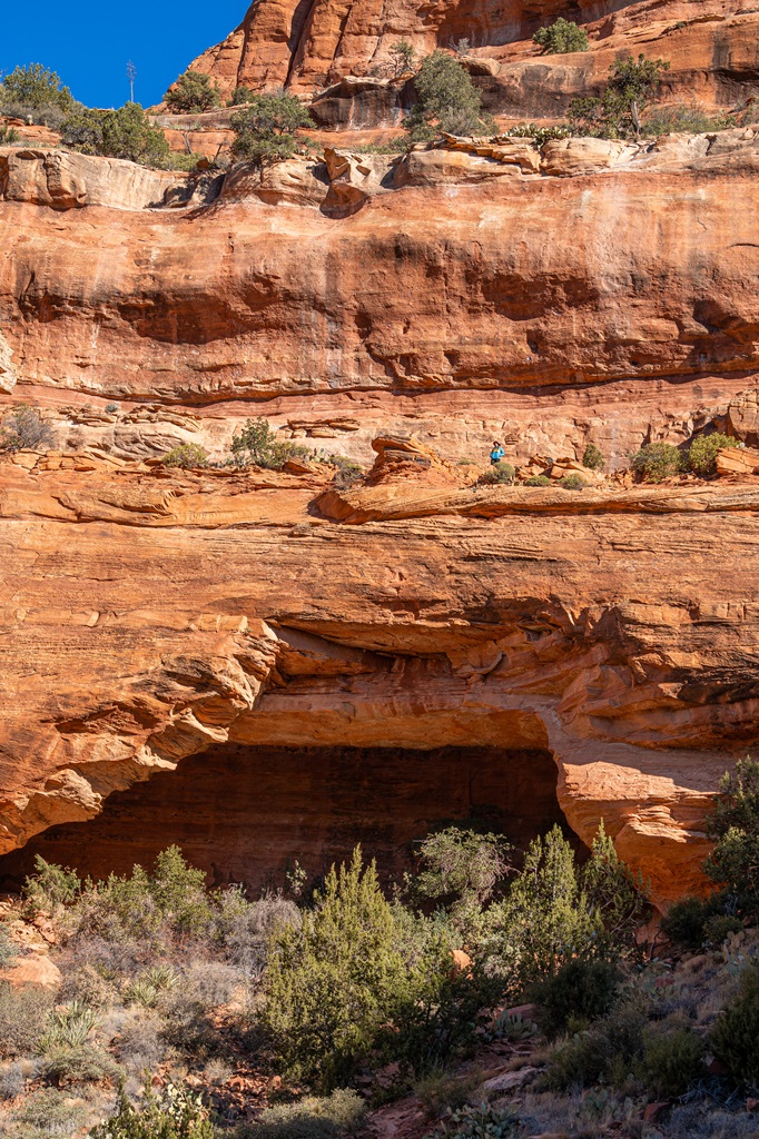 View of the entire Fay Canyon Arch with woman standing at the top.