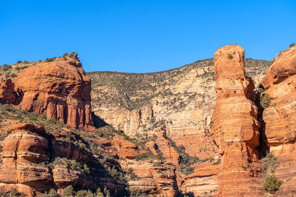 View of red sandstone walls and unique rock formations along the Fay Canyon Arch Trail.