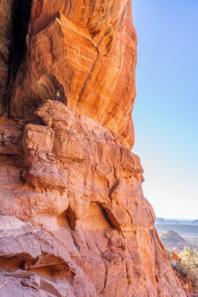 Man standing on a ledge inside the Keyhole Cave in Sedona.