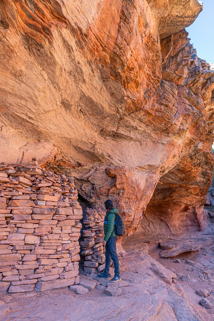 Man looking inside a Native American cliff dwelling near the Subway Cave in Sedona.