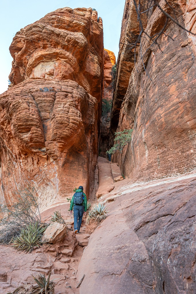 Man walking towards the base of Subway Cave in Sedona.