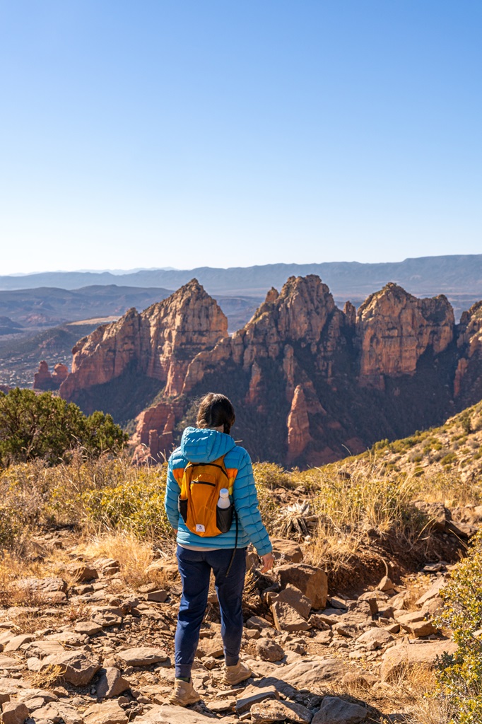 Woman hiking down the Wilson Mountain Trail in Sedona.