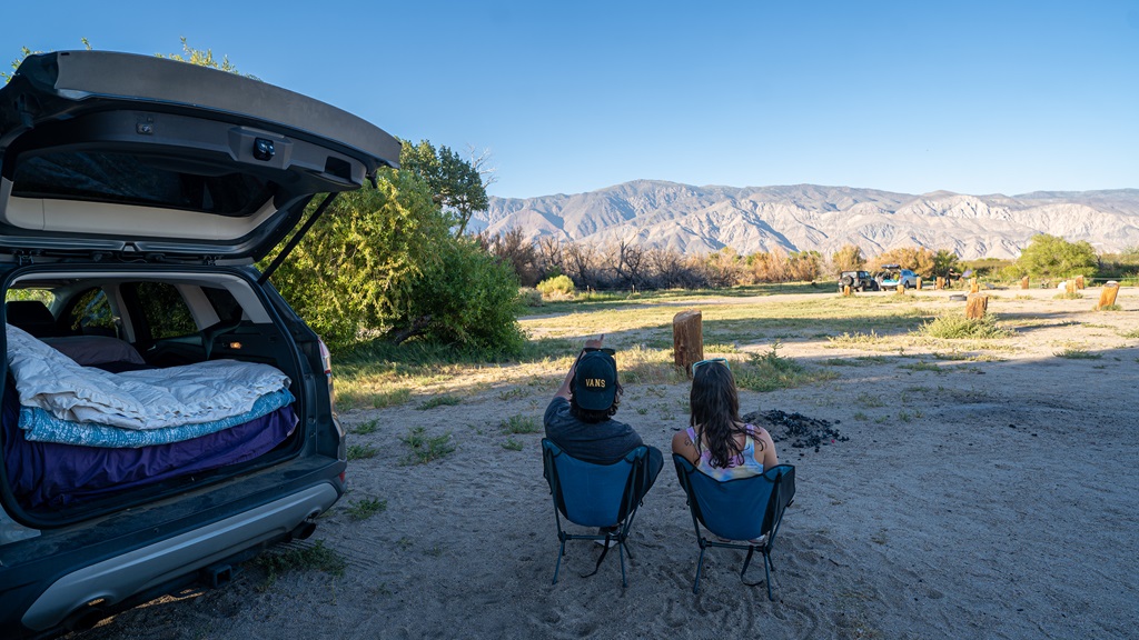 Man and woman car camping at the Diaz Lake Campground near Lone Pine, California.