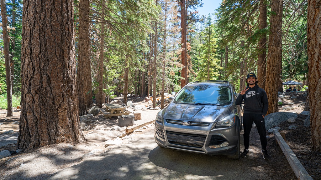 Man standing beside his car at a campsite at the Whitney Portal Campground near Lone Pine, California.