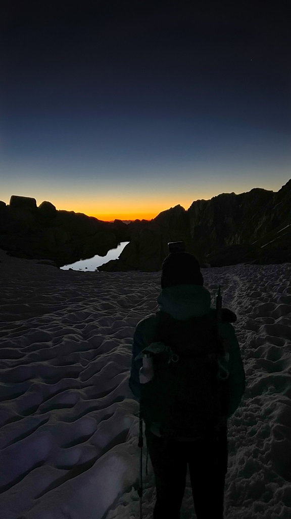 Woman watching the sunrise along the Mt Whitney Trail near Trail Camp.