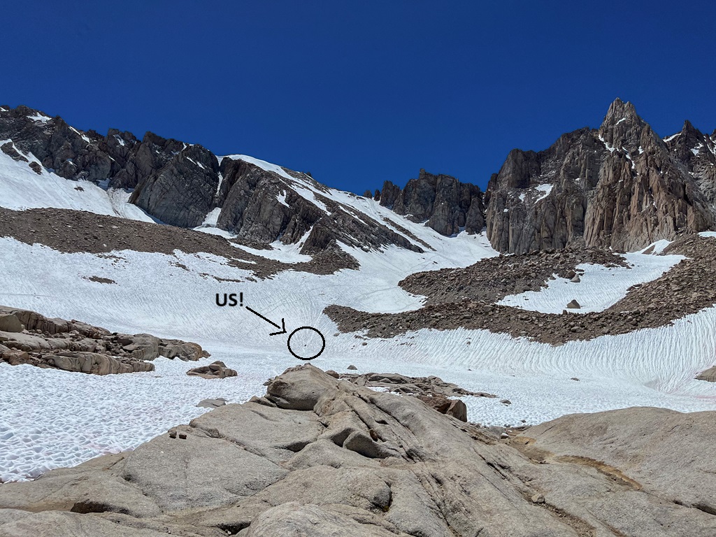 View of man and woman glissading down the chute from Trail Crest towards Trail Camp.