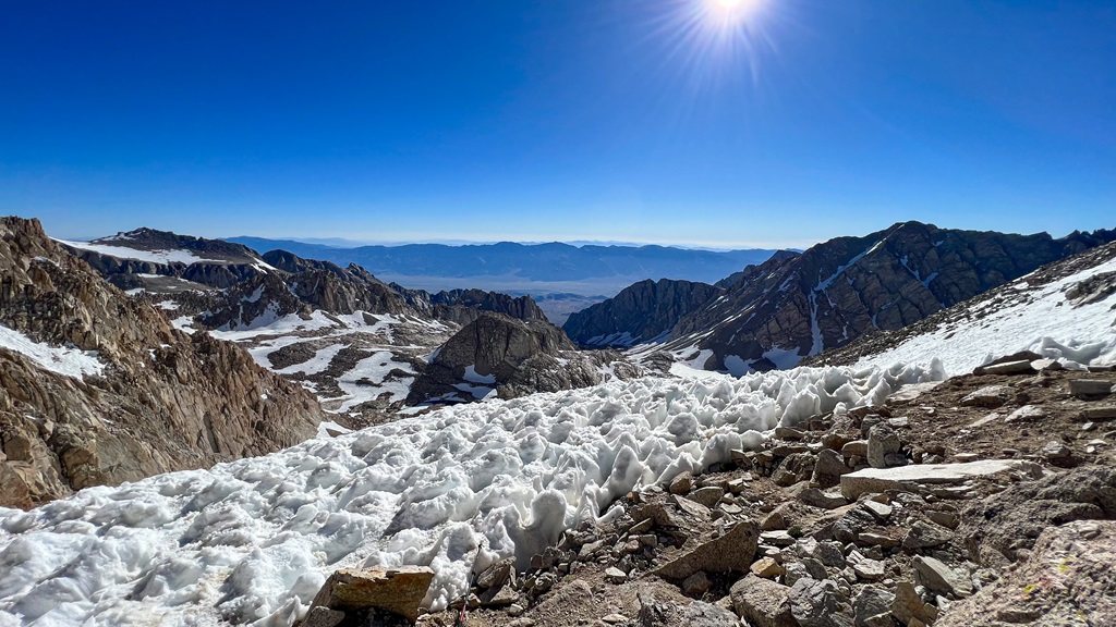 View of snowy mountains and Alabama Hills from the top of Trail Crest near Mt Whitney.