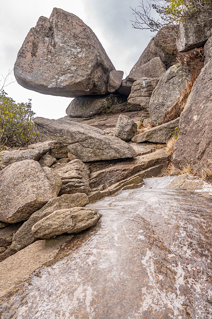 Ice along a small section of the Old Rock Scramble with a unique rock formation in the background.